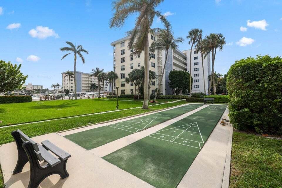 1 Harbourside Drive, Unit 4205 Delray Beach, FL 33483 - Photo 75 of 97 a view of a white house in a big yard with palm trees