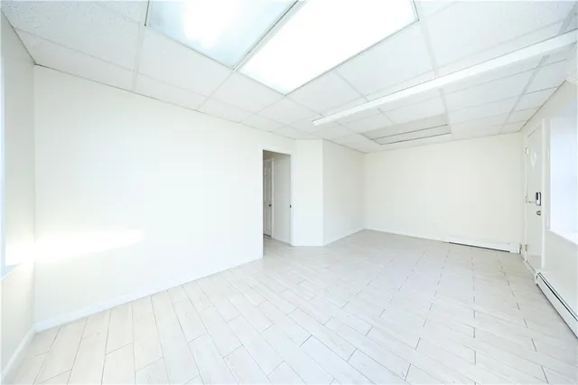 a view of empty room with wooden floor and closet