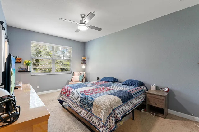 a bedroom with a bed and window