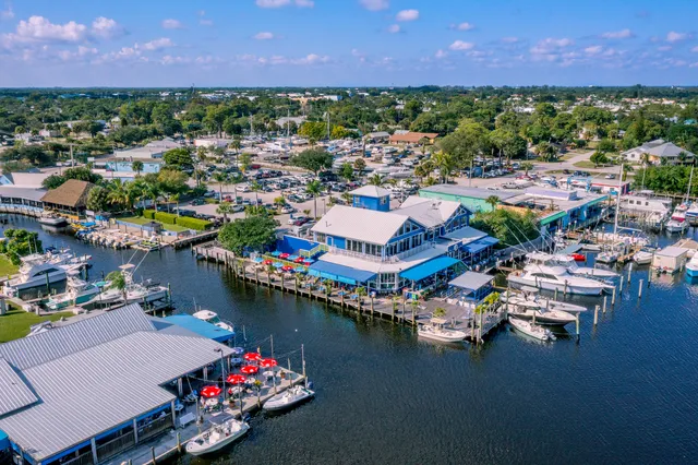 a view of a lake with a house swimming pool outdoor seating and a lake view
