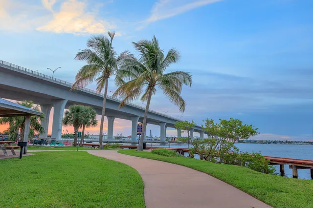 a view of a house with a big yard and potted plants
