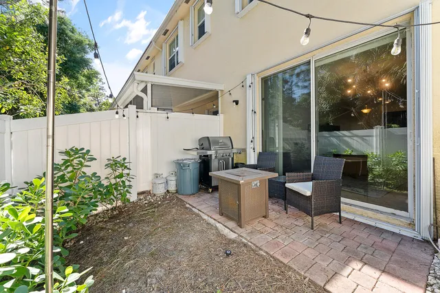 a view of a patio with table and chairs potted plants with wooden fence
