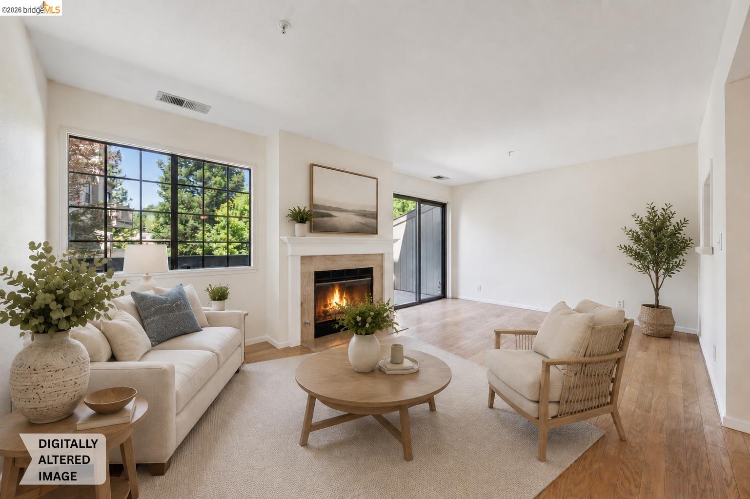 261 Redhawk Road Novato, CA 94949 - Photo 15 of 47 Spacious living area featuring a fireplace with a stone surround and a white mantel, large grid-pattern windows, light wood-finish flooring, and a sliding glass door