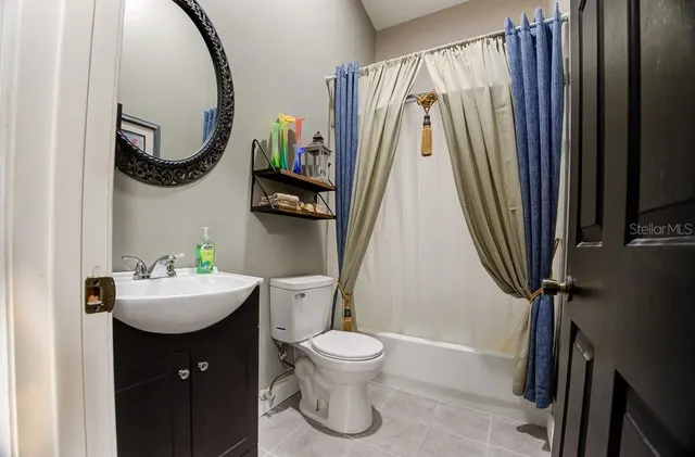 a view of a patio with table and chairs under an umbrella with a small yard