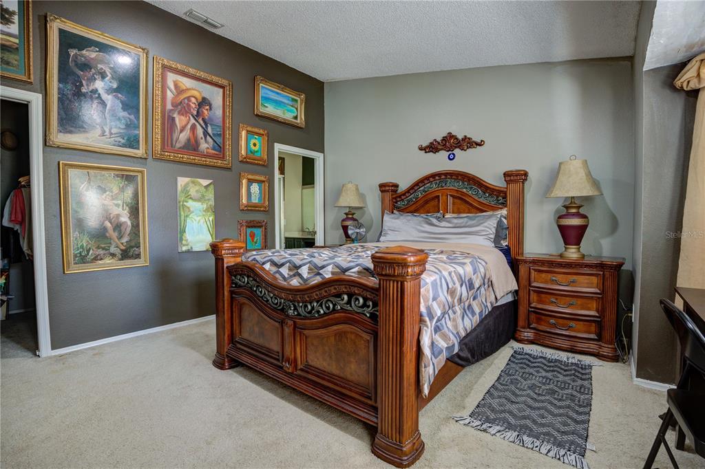 567 Silver Course Run Ocala, FL 34472 - Photo 24 of 95 a bedroom with a bed and wooden floor