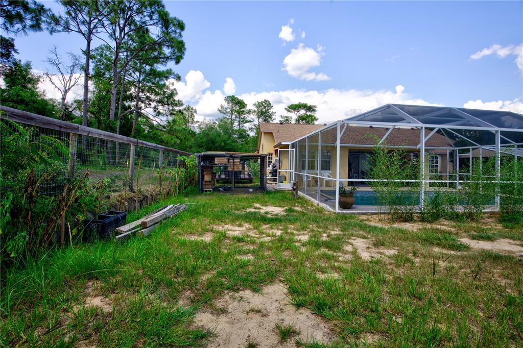 567 Silver Course Run Ocala, FL 34472 - Photo 62 of 95 a view of a yard with plants and a garden