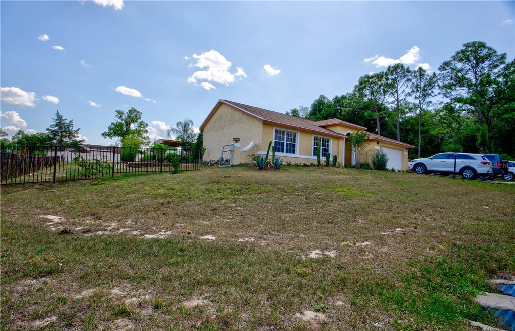567 Silver Course Run Ocala, FL 34472 - Photo 65 of 95 a view of a house with a big yard and a large tree
