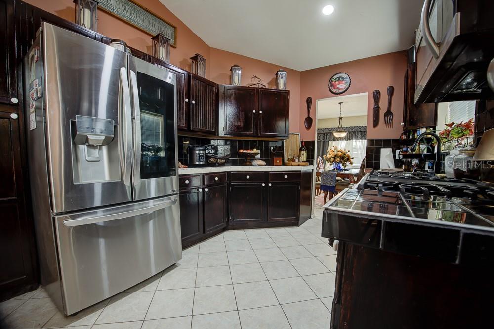 567 Silver Course Run Ocala, FL 34472 - Photo 7 of 95 a kitchen with stainless steel appliances granite countertop a sink stove and refrigerator