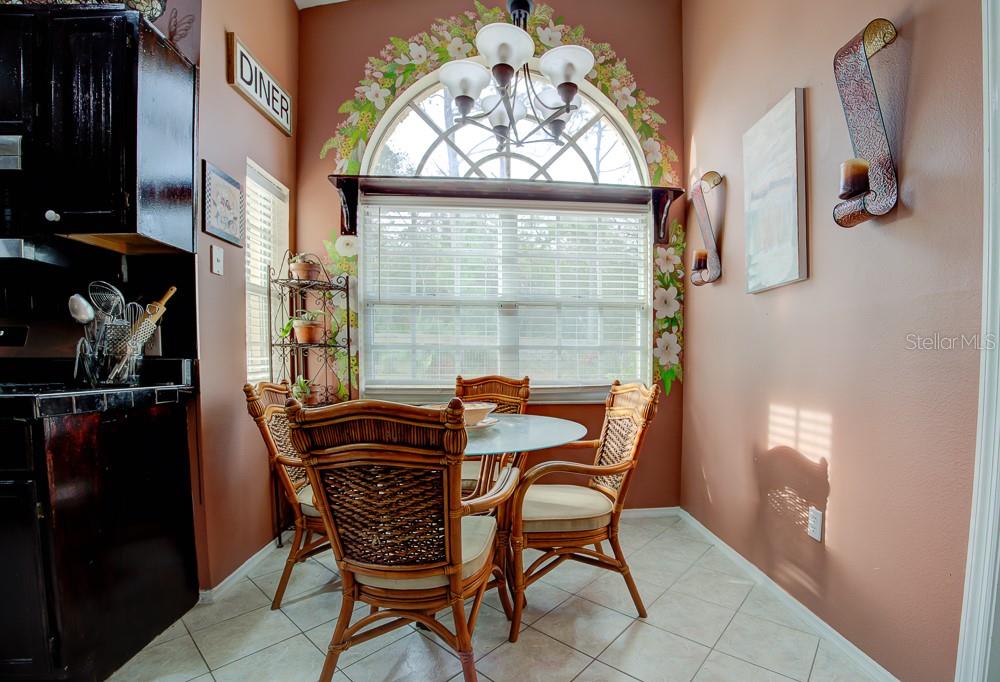 567 Silver Course Run Ocala, FL 34472 - Photo 10 of 95 a view of a dining room with furniture and a window