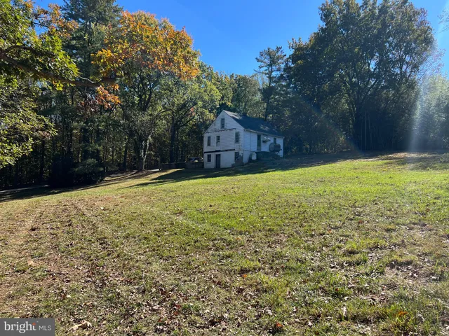 a view of a yard with a house in the background