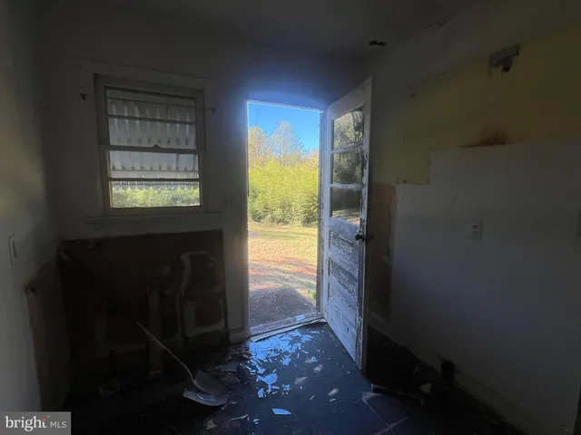 a view of an empty room and a window