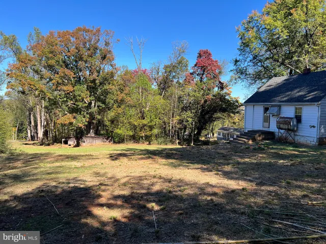 a blue house with trees in front of it