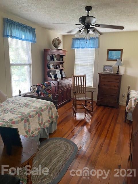 115 Amble Road Olin, NC 28660 - Photo 15 of 47 a bedroom with a bed and wooden floor