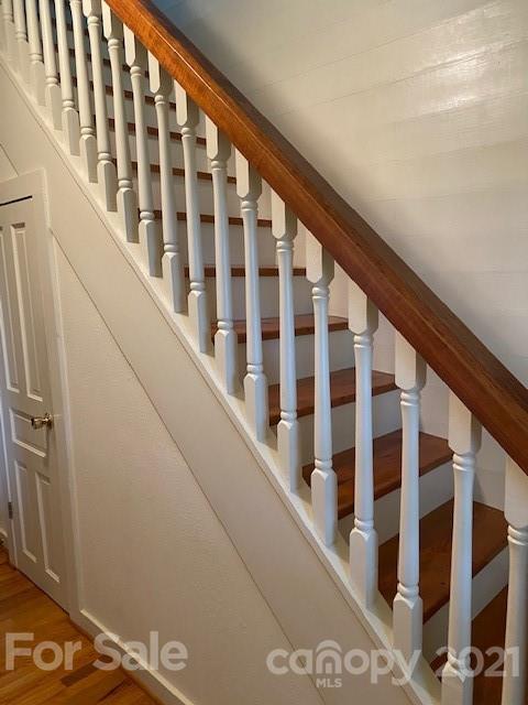 115 Amble Road Olin, NC 28660 - Photo 21 of 47 a view of staircase with lots of white walls and a black gate