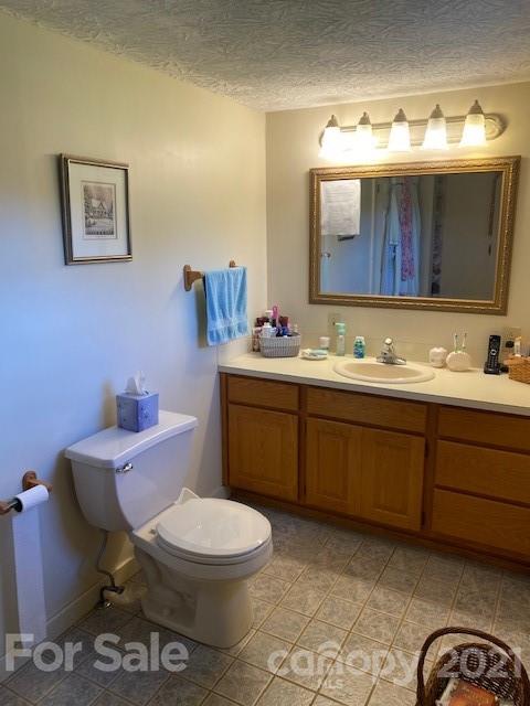 115 Amble Road Olin, NC 28660 - Photo 22 of 47 a bathroom with a toilet a sink and mirror