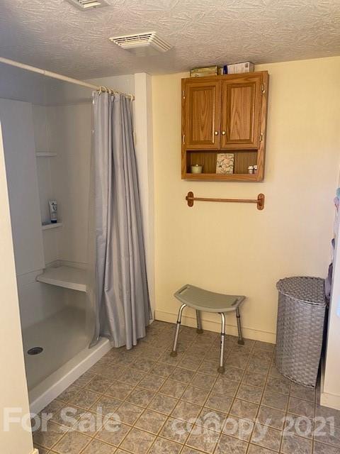 115 Amble Road Olin, NC 28660 - Photo 23 of 47 a chair and a table in a room
