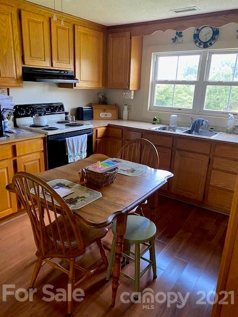 115 Amble Road Olin, NC 28660 - Photo 6 of 47 a kitchen with stainless steel appliances granite countertop a table chairs sink and cabinets