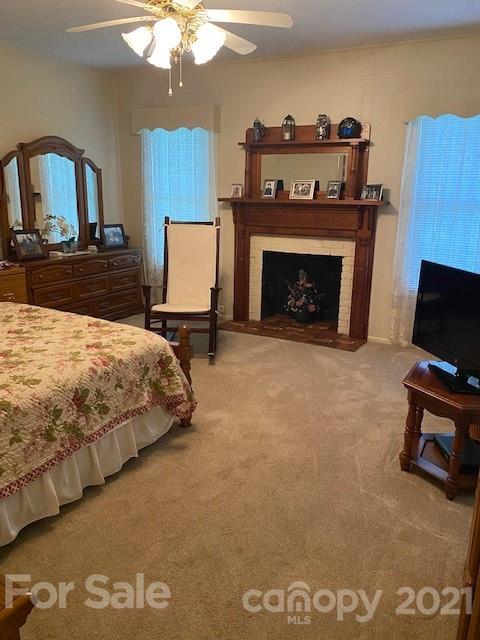 115 Amble Road Olin, NC 28660 - Photo 9 of 47 a bedroom with a bed and a fireplace