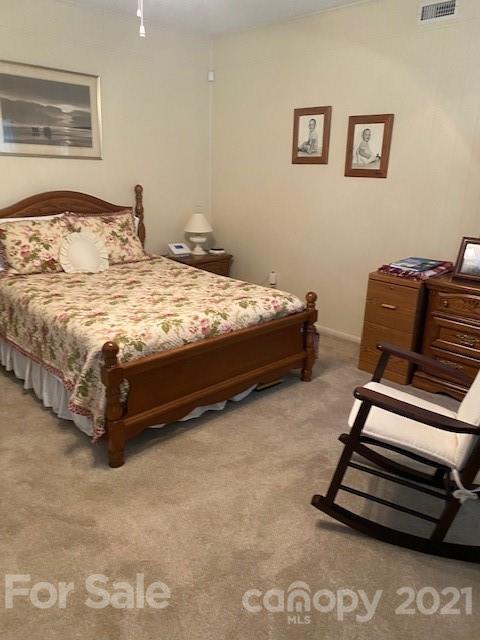 115 Amble Road Olin, NC 28660 - Photo 10 of 47 a bedroom with a bed and a dresser with rug