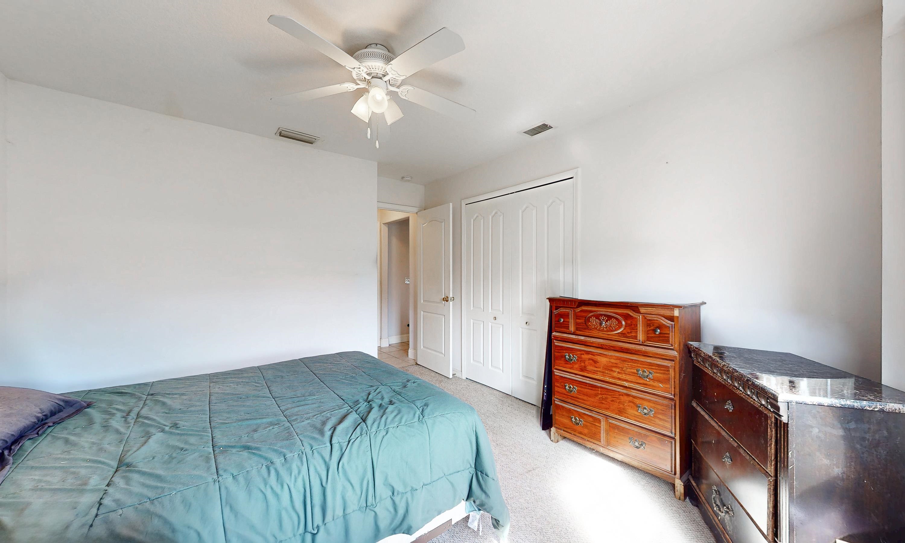 330 Segovia Road St. Augustine, FL 32086 - Photo 18 of 52 a bedroom with a bed and a chandelier
