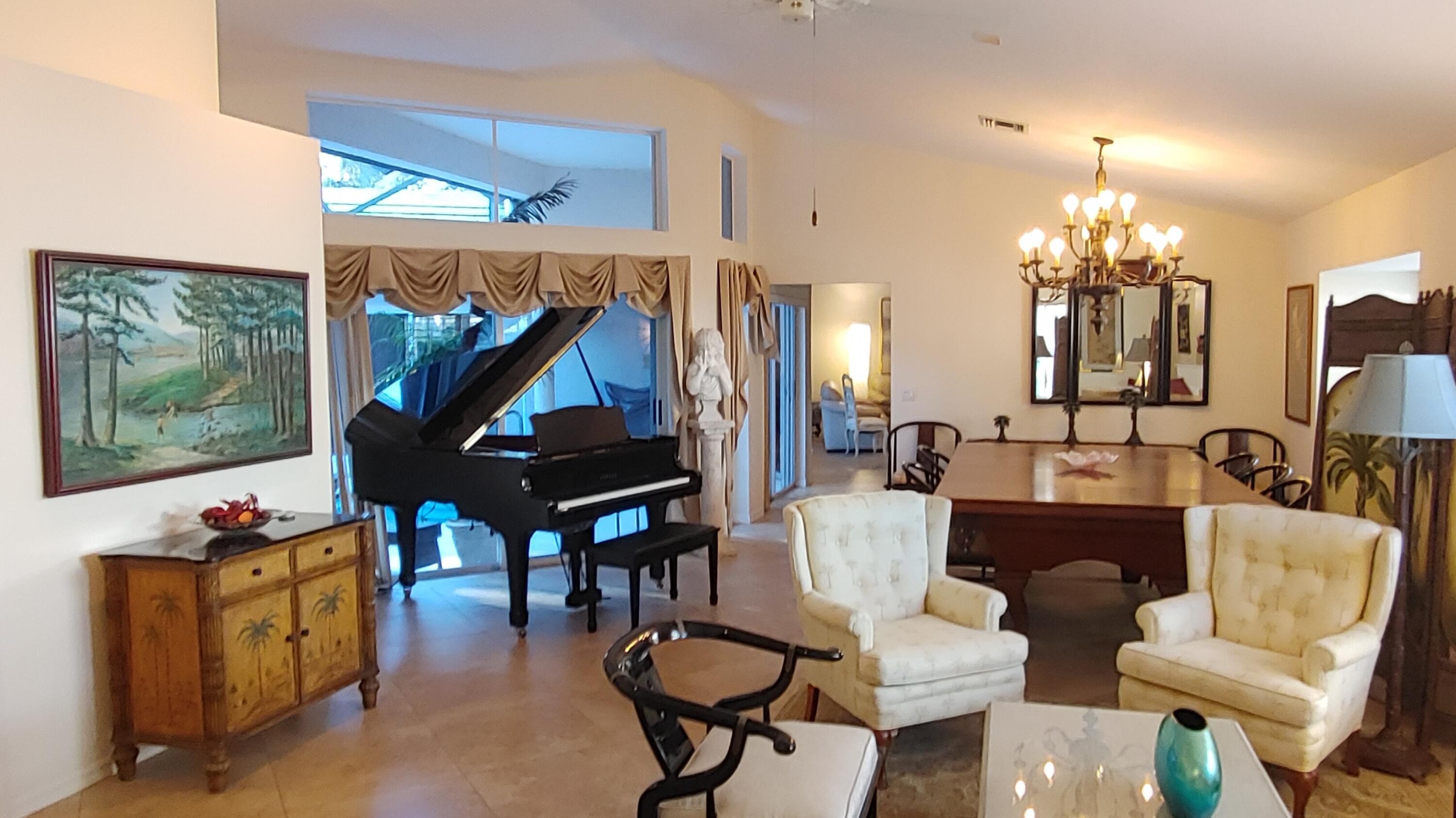 16461 Riverwind Drive Jupiter, FL 33477 - Photo 1 of 45 a living room with furniture and a chandelier