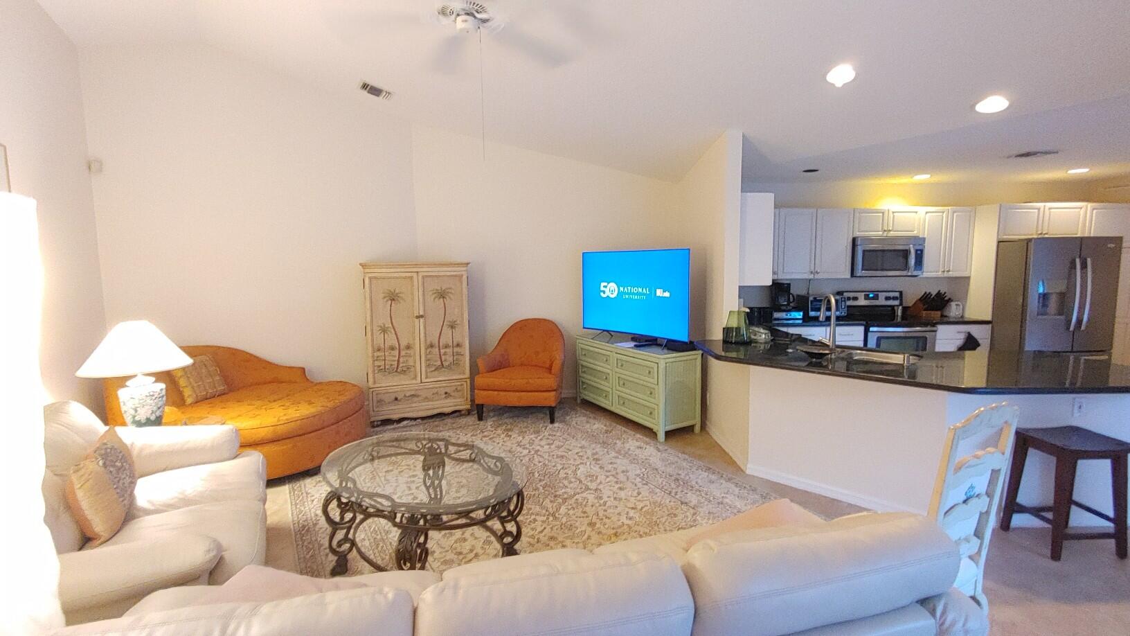 16461 Riverwind Drive Jupiter, FL 33477 - Photo 12 of 45 a living room with furniture and kitchen view