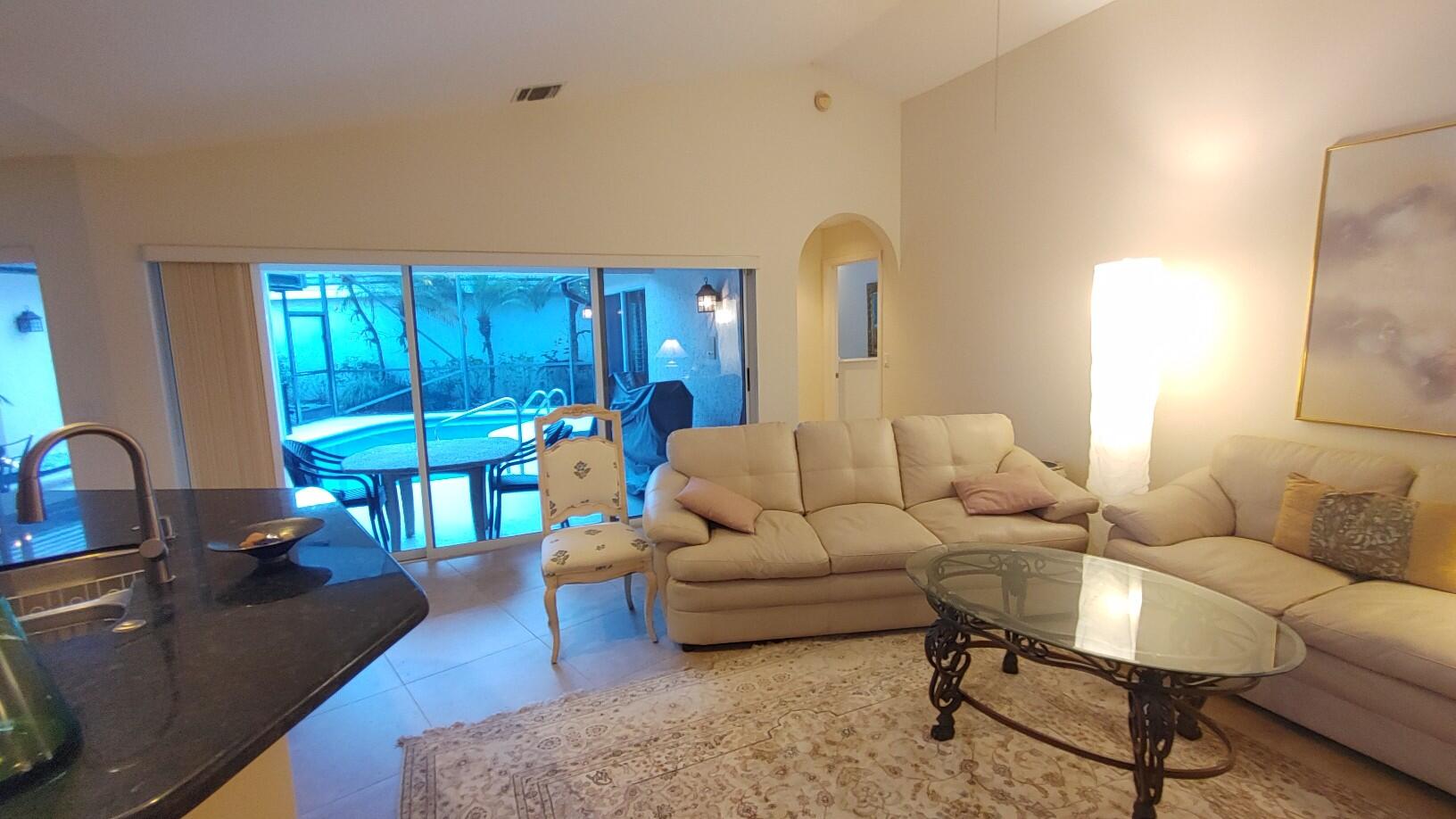 16461 Riverwind Drive Jupiter, FL 33477 - Photo 14 of 45 a living room with furniture and a wooden floor