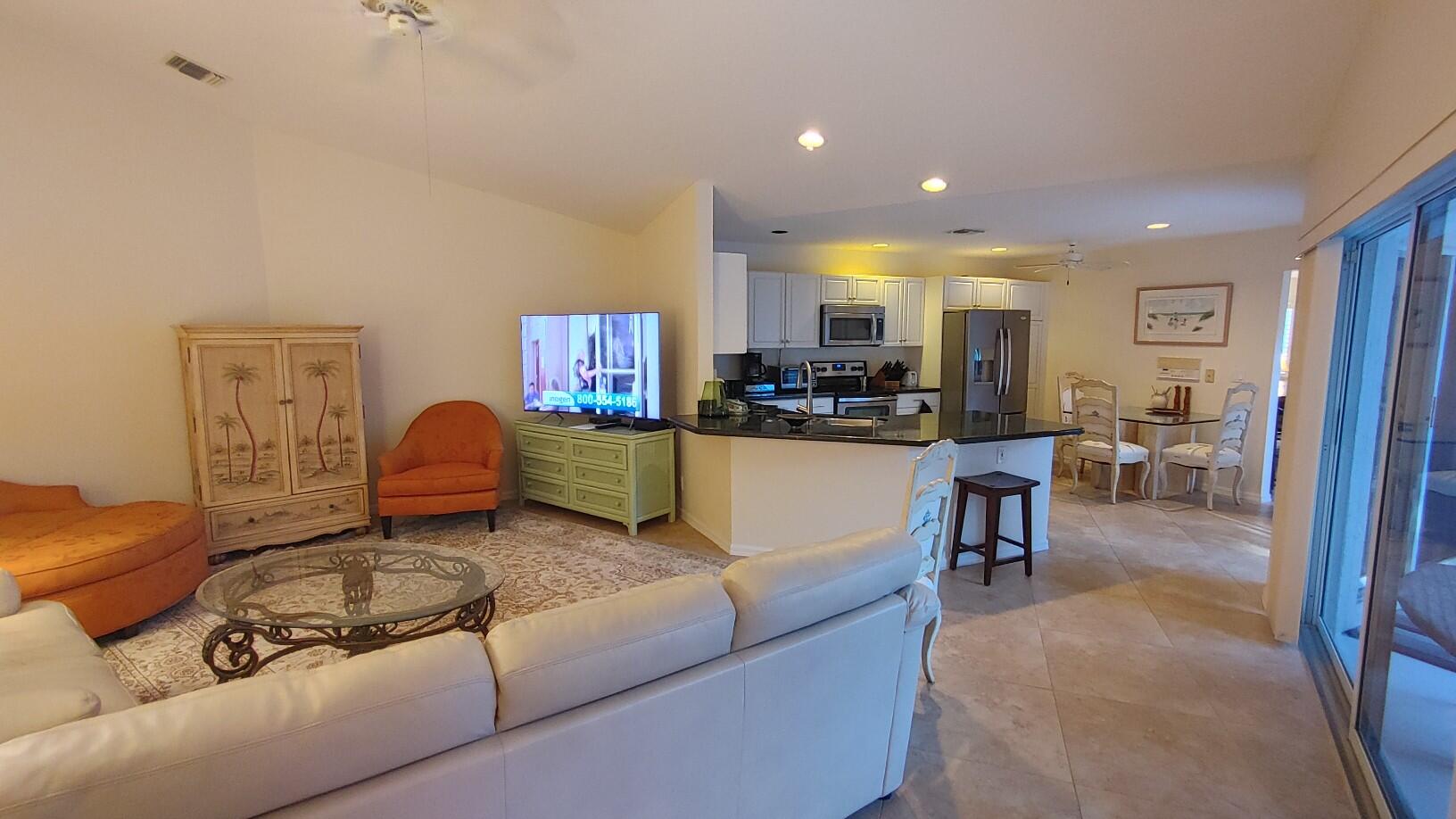 16461 Riverwind Drive Jupiter, FL 33477 - Photo 18 of 45 a living room with furniture and kitchen view