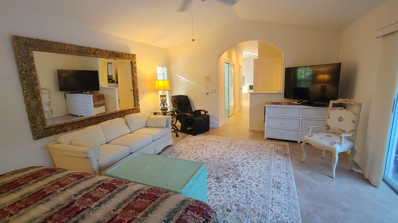16461 Riverwind Drive Jupiter, FL 33477 - Photo 22 of 45 a living room with furniture and a flat screen tv