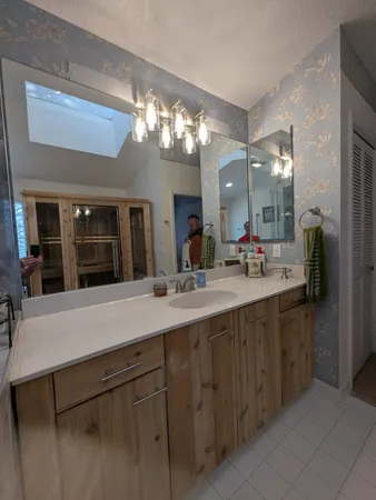 a bathroom with a sink vanity and a mirror