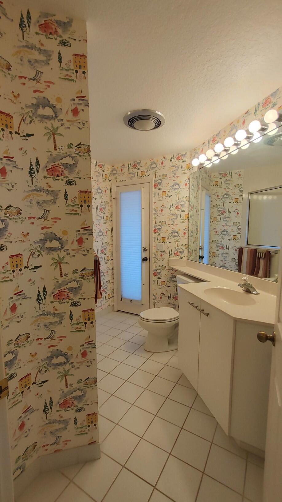 16461 Riverwind Drive Jupiter, FL 33477 - Photo 30 of 45 a bathroom with a sink and a mirror