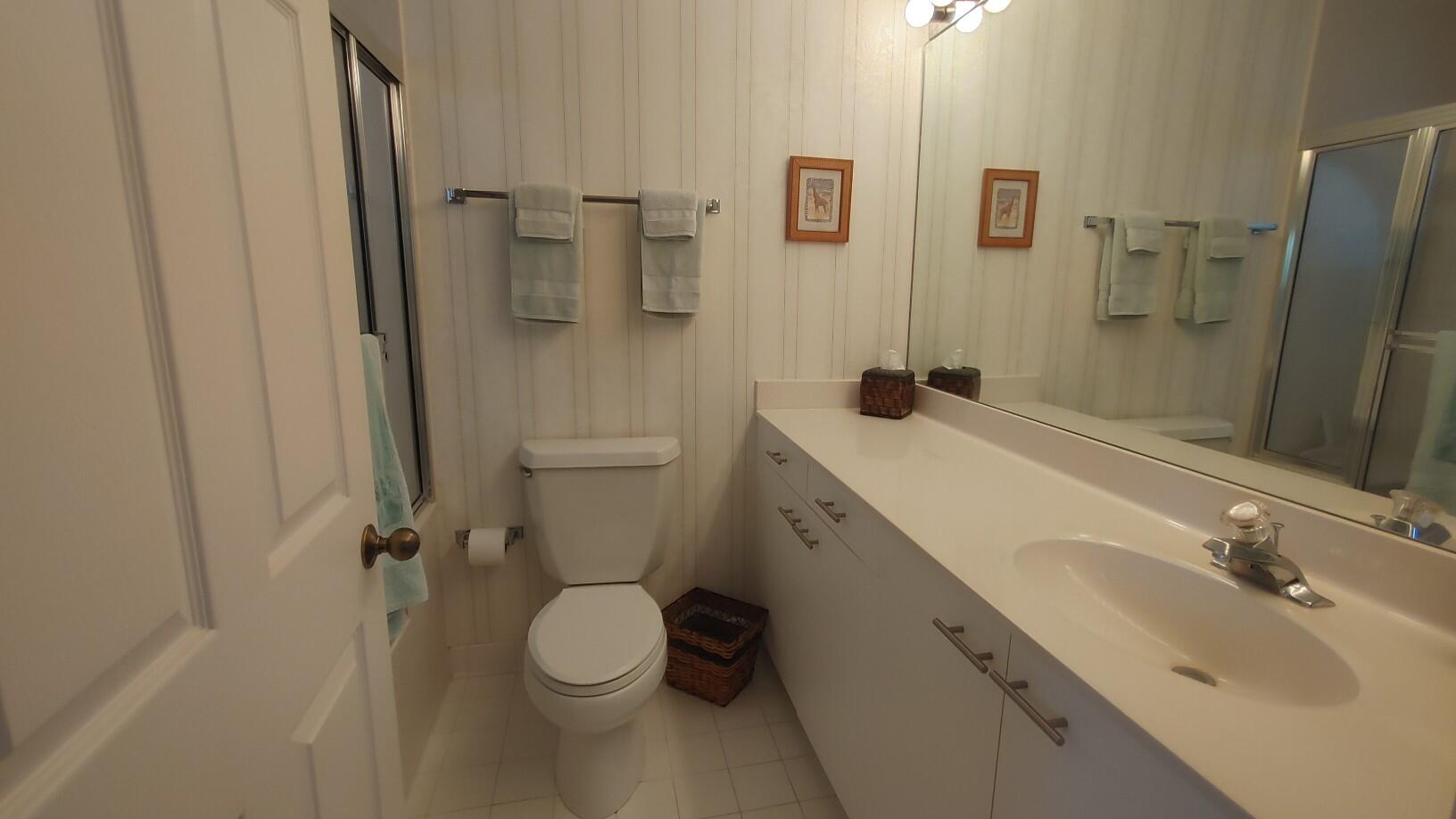 16461 Riverwind Drive Jupiter, FL 33477 - Photo 32 of 45 a bathroom with a sink toilet and shower