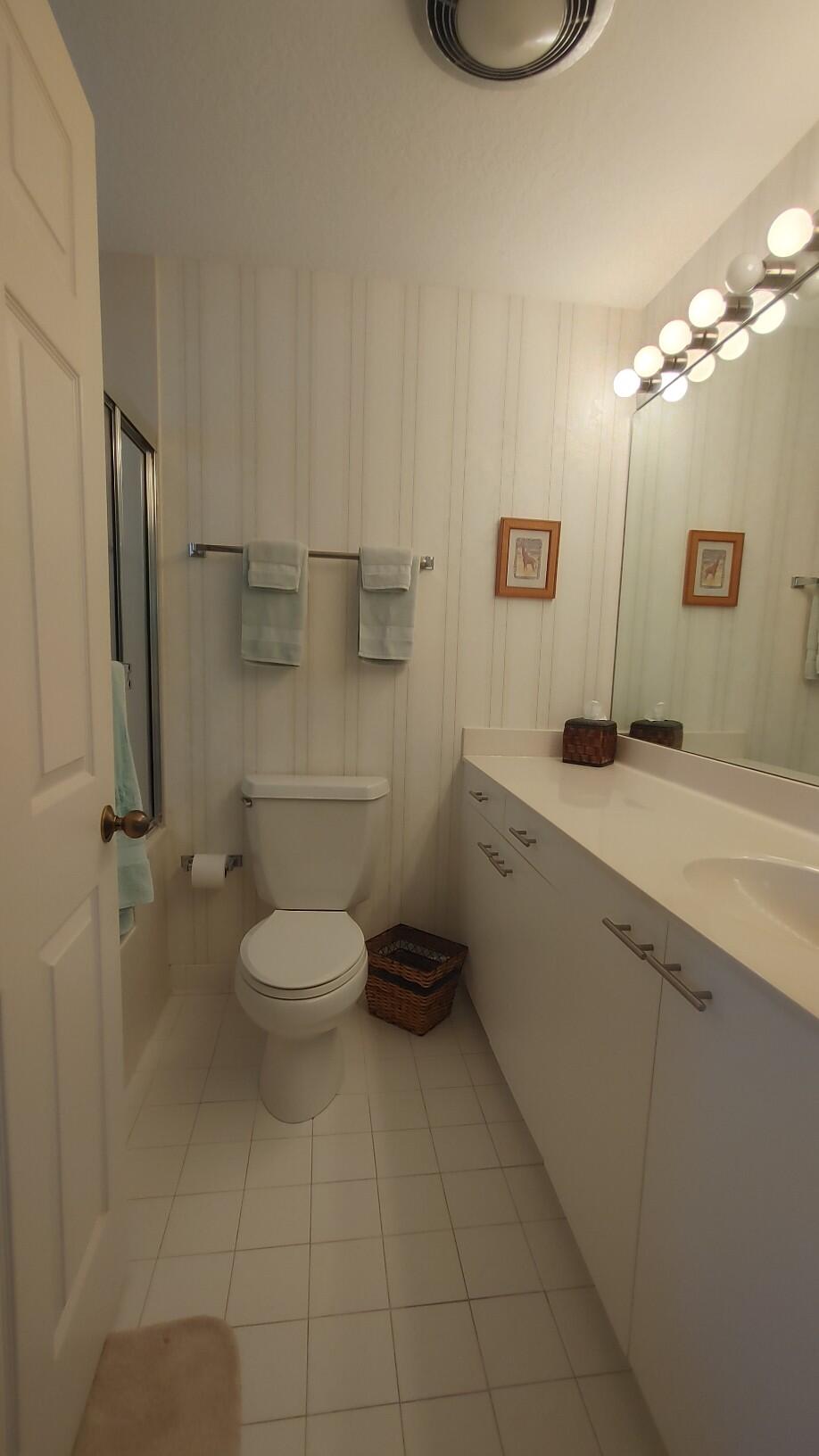 16461 Riverwind Drive Jupiter, FL 33477 - Photo 34 of 45 a bathroom with a granite countertop toilet sink and shower