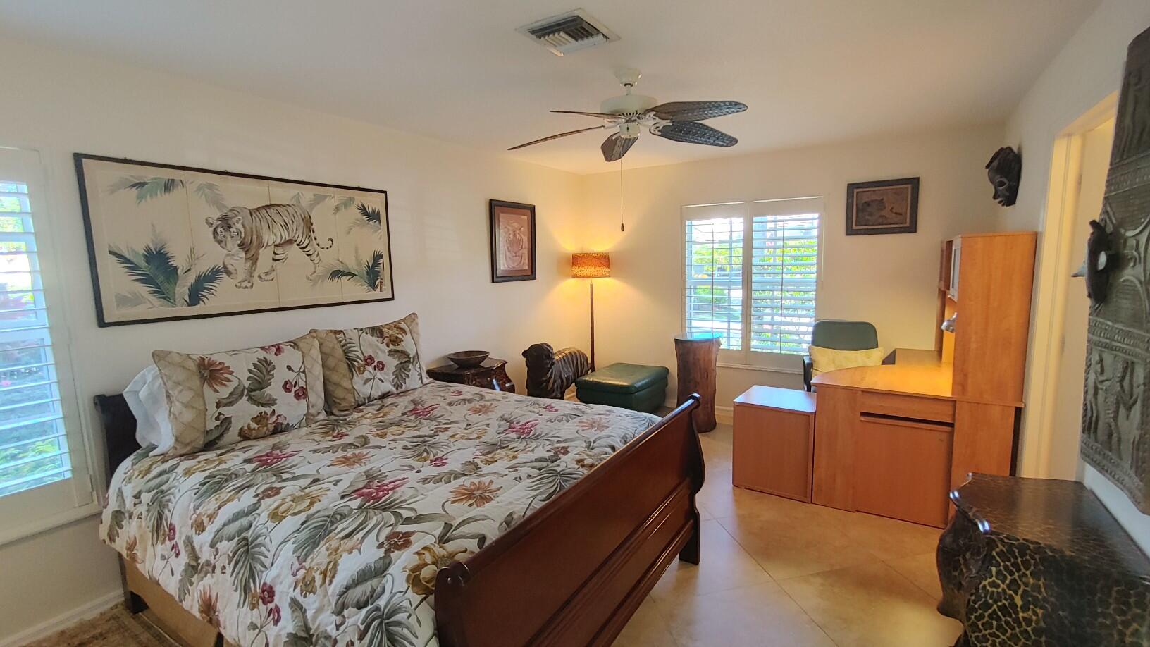 16461 Riverwind Drive Jupiter, FL 33477 - Photo 37 of 45 a bedroom with a bed and wooden floor