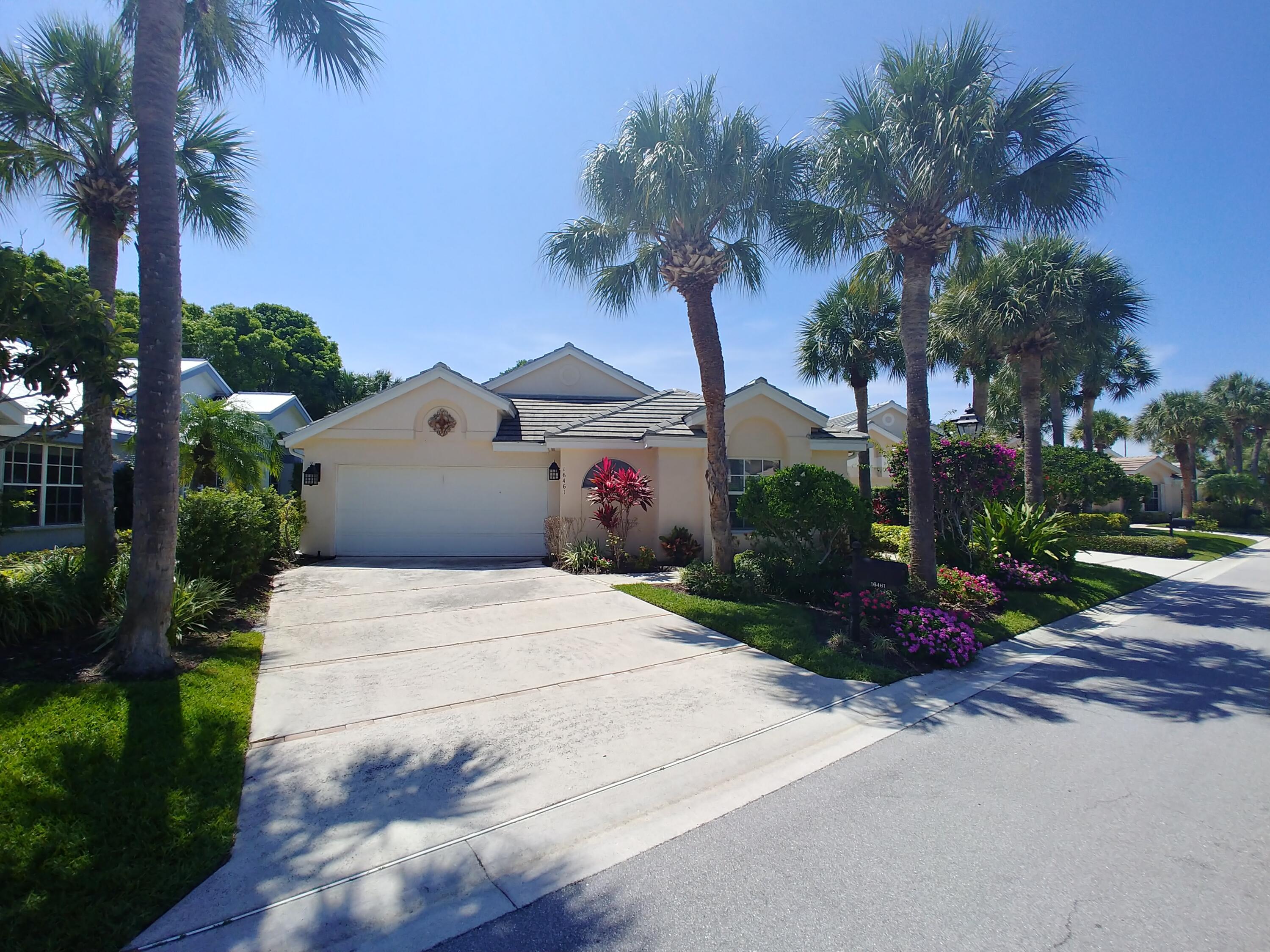 16461 Riverwind Drive Jupiter, FL 33477 - Photo 45 of 45 a front view of a house with garden