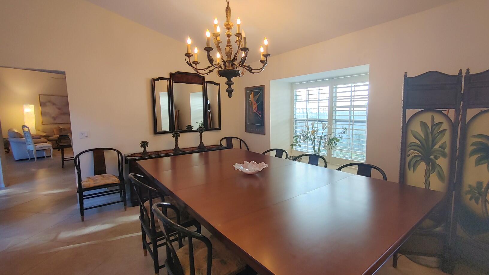 16461 Riverwind Drive Jupiter, FL 33477 - Photo 5 of 45 a view of a dining room with furniture window and wooden floor