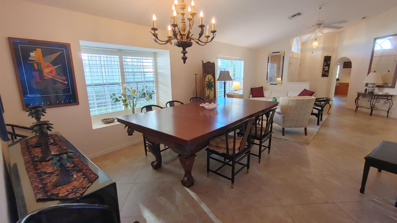 16461 Riverwind Drive Jupiter, FL 33477 - Photo 6 of 45 a view of a dining room with furniture window and wooden floor