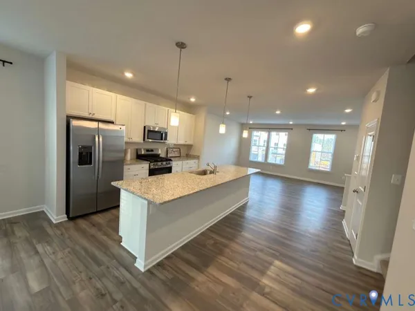 a view of kitchen with cabinets and wooden floor