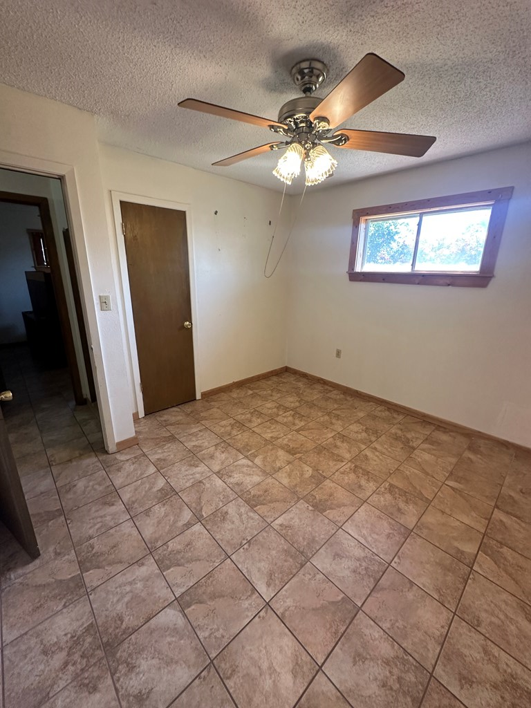 104 South Ave B Mason, TX 76856 - Photo 12 of 26 an empty room with windows and fan