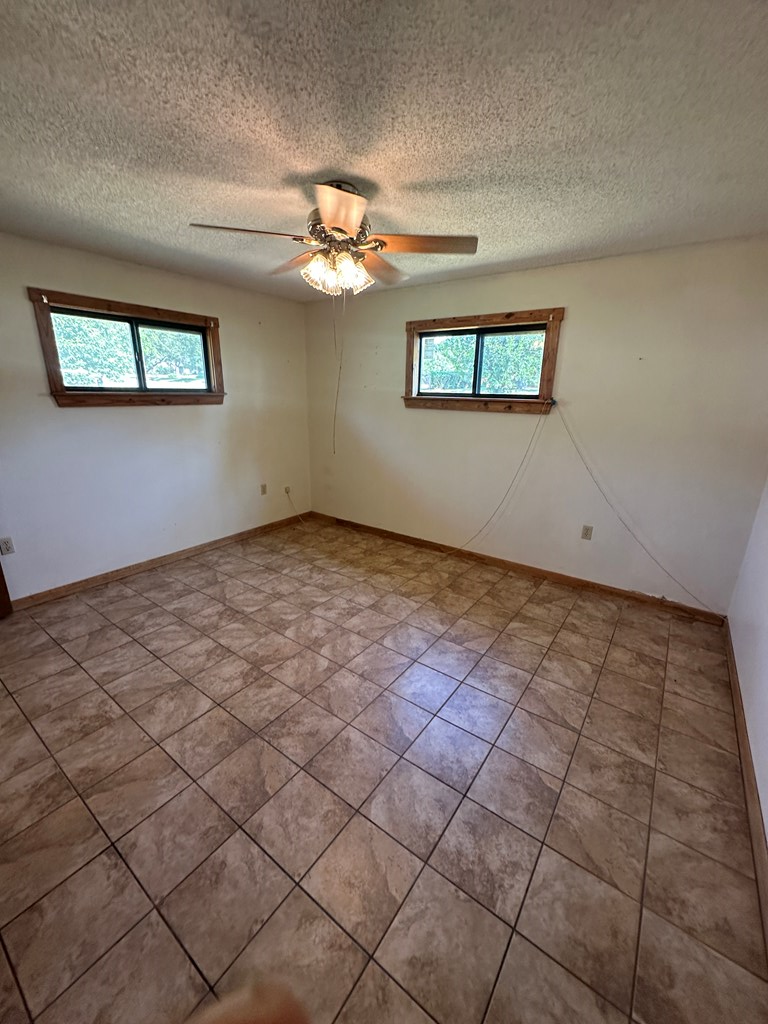 104 South Ave B Mason, TX 76856 - Photo 17 of 26 a view of a big room with windows and chandelier fan