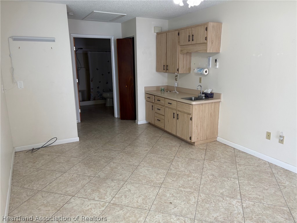 3913 Ferrari Drive Sebring, FL 33872 - Photo 17 of 20 a room with a cabinets and a stove
