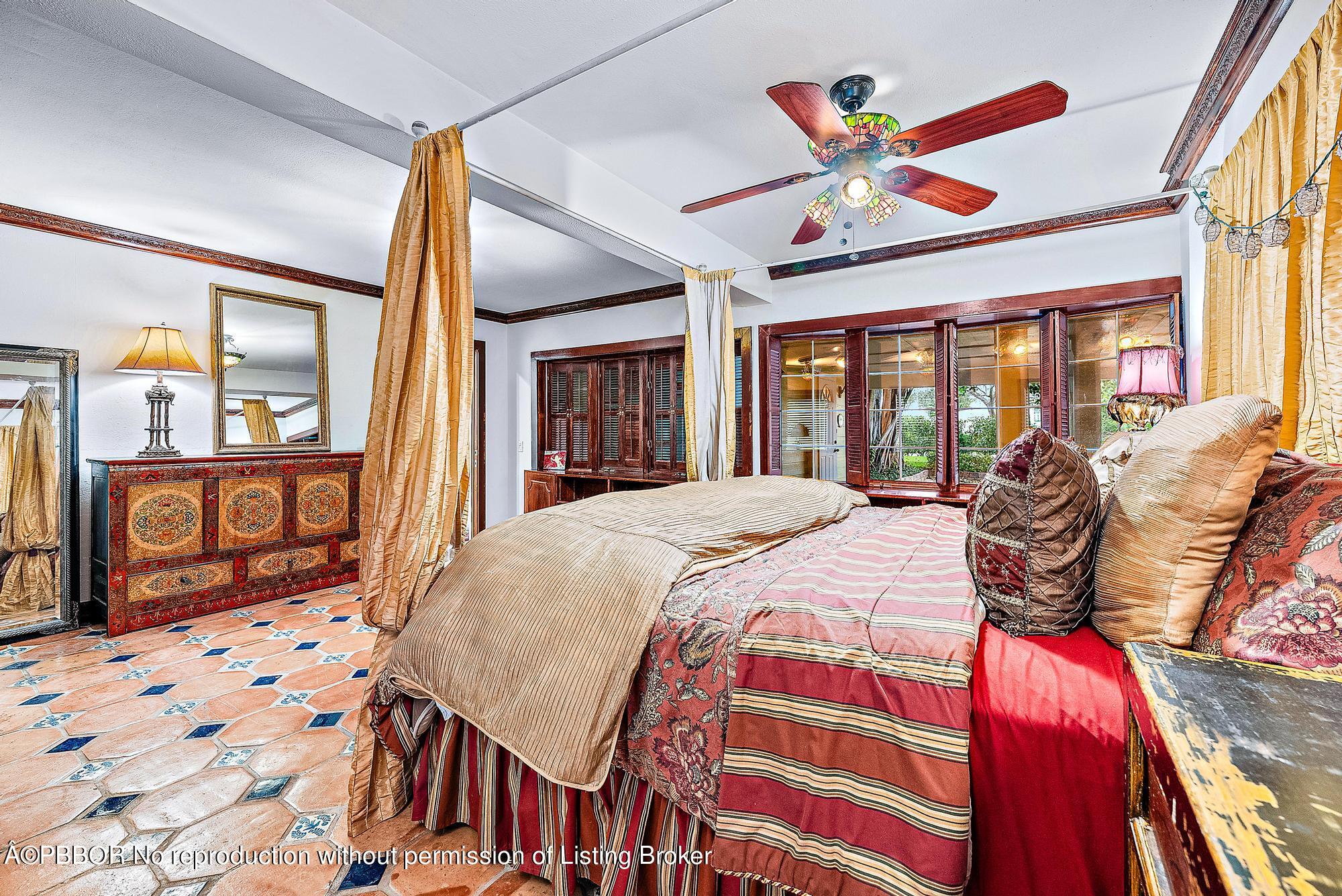 3609 Washington Road West Palm Beach, FL 33405 - Photo 23 of 33 a bedroom with a bed and a large mirror with the outer view