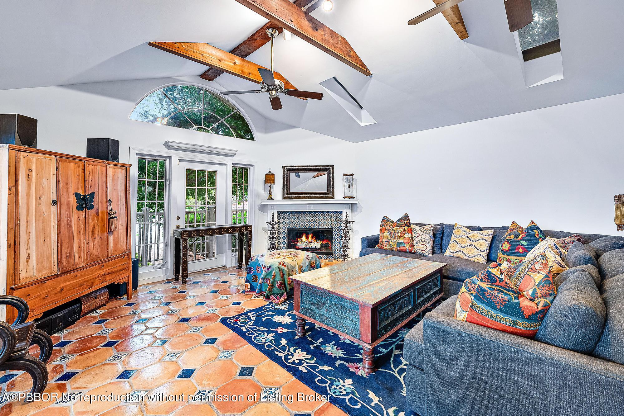 3609 Washington Road West Palm Beach, FL 33405 - Photo 4 of 33 a living room with furniture a flat screen tv and a fireplace