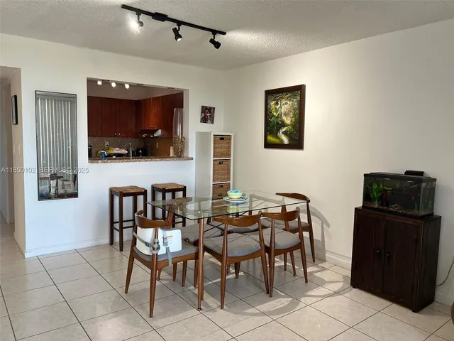 a view of a dining room with furniture and a flat screen tv