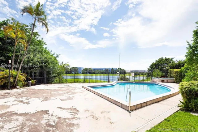 a view of a swimming pool with a yard