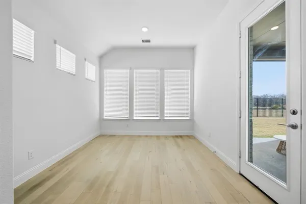 a view of a room with wooden floor and doors