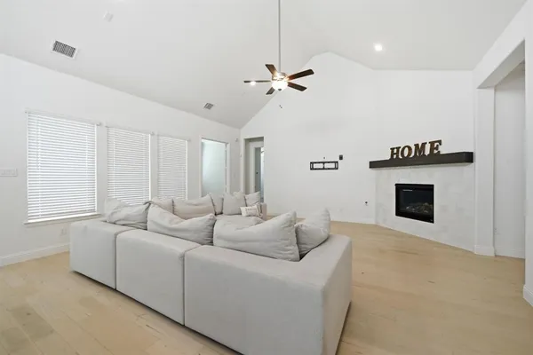 a living room with furniture a fireplace and a window