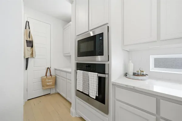 a kitchen with stainless steel appliances a stove microwave and sink
