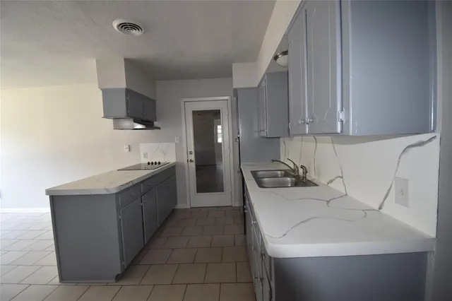 a kitchen with stainless steel appliances a sink stove and refrigerator
