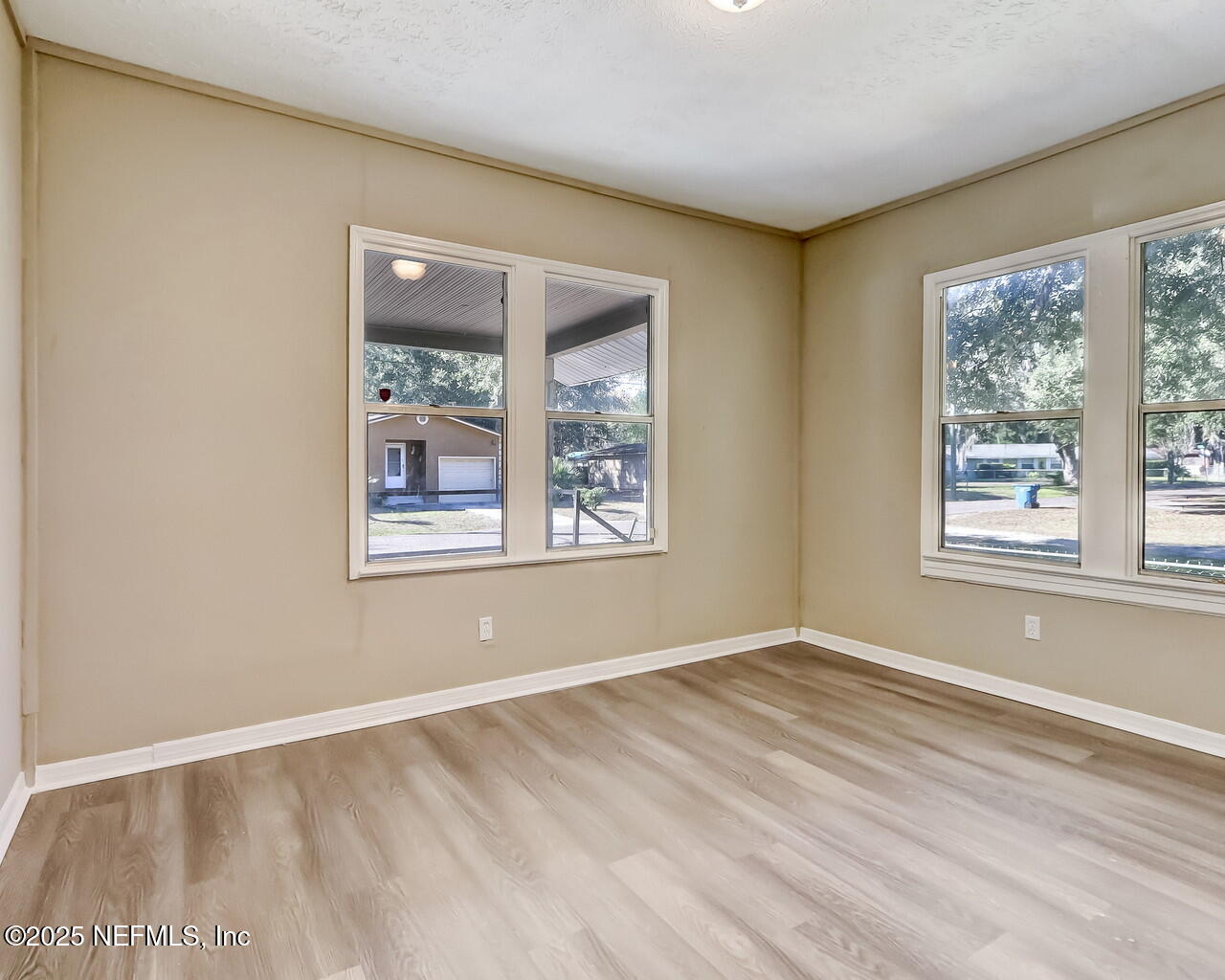 8951 6th Avenue Jacksonville, FL 32208 - Photo 18 of 29 a view of an empty room with window and wooden floor